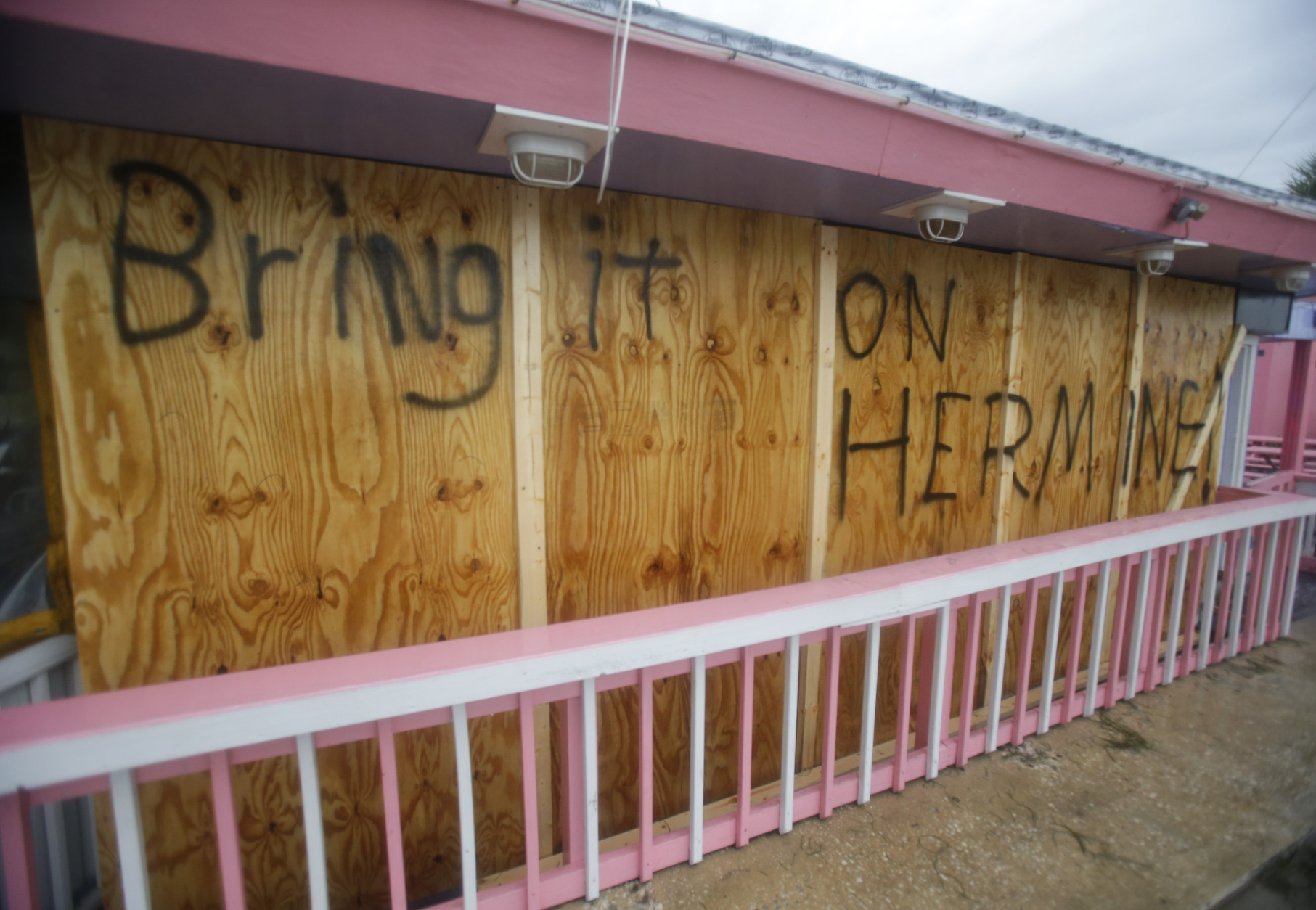 A hand painted sign on a boarded up bar is seen as Hurricane Hermine nears the Florida coast, Thursday, Sept. 1, 2016, in Cedar Key, Fla. ﻿Hurricane Hermine gained new strength Thursday evening and roared ever closer to Florida's Gulf Coast, where rough surf began smashing against docks and boathouses and people braced for the first direct hit on the state from a hurricane in over a decade. ﻿(AP Photo/John Raoux)