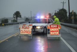 Police block the road entering Cedar Key, Fla., as Hurricane Hermine nears the Florida coast, Thursday, Sept. 1, 2016. Hurricane Hermine gained new strength Thursday evening and roared ever closer to Florida's Gulf Coast, where rough surf began smashing against docks and boathouses and people braced for the first direct hit on the state from a hurricane in over a decade. (AP Photo/John Raoux)