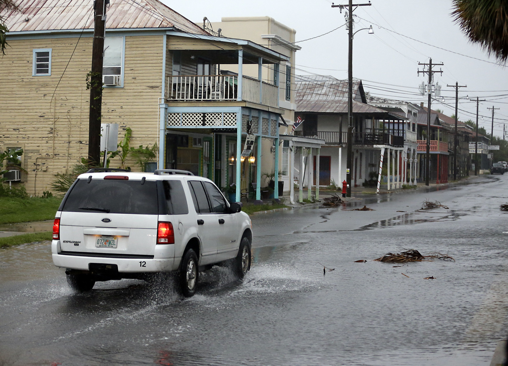 A vehicle makes it way through the downtown area of Cedar Key, Fla., as Hurricane Hermine nears the Florida coast, Thursday, Sept. 1, 2016. (AP Photo/John Raoux)