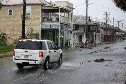 A vehicle makes it way through the downtown area of Cedar Key, Fla., as Hurricane Hermine nears the Florida coast, Thursday, Sept. 1, 2016. (AP Photo/John Raoux)