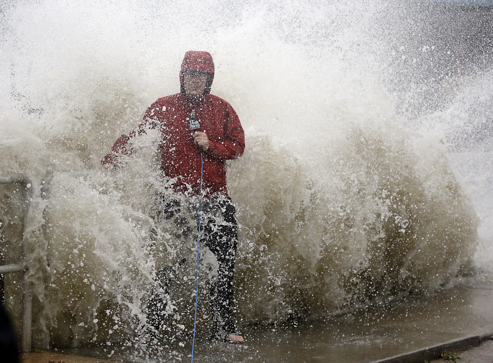 A news reporter doing a stand up near a sea wall in Cedar Key, Fla., is covered by an unexpected wave as Hurricane Hermine nears the Florida coast, Thursday, Sept. 1, 2016. Hurricane Hermine gained new strength Thursday evening and roared ever closer to Florida's Gulf Coast, where rough surf began smashing against docks and boathouses and people braced for the first direct hit on the state from a hurricane in over a decade. (AP Photo/John Raoux)