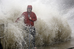 A news reporter doing a stand up near a sea wall in Cedar Key, Fla., is covered by an unexpected wave as Hurricane Hermine nears the Florida coast, Thursday, Sept. 1, 2016. Hurricane Hermine gained new strength Thursday evening and roared ever closer to Florida's Gulf Coast, where rough surf began smashing against docks and boathouses and people braced for the first direct hit on the state from a hurricane in over a decade. (AP Photo/John Raoux)