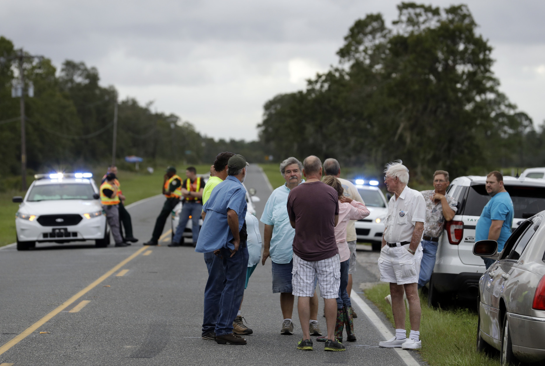 Resident wait to be let in to check their homes in Keaton Beach, Fla., after Hurricane Hermine made landfall in the Florida panhandle early Friday, Sept. 2, 2016, in Keaton Beach, Fla. Hermine was downgraded to a tropical storm after it made landfall, as it moves over Georgia, but the U.S. National Hurricane Center says winds are increasing along the Southeast coast and flooding rains continue.  (AP Photo/Chris O'Meara)