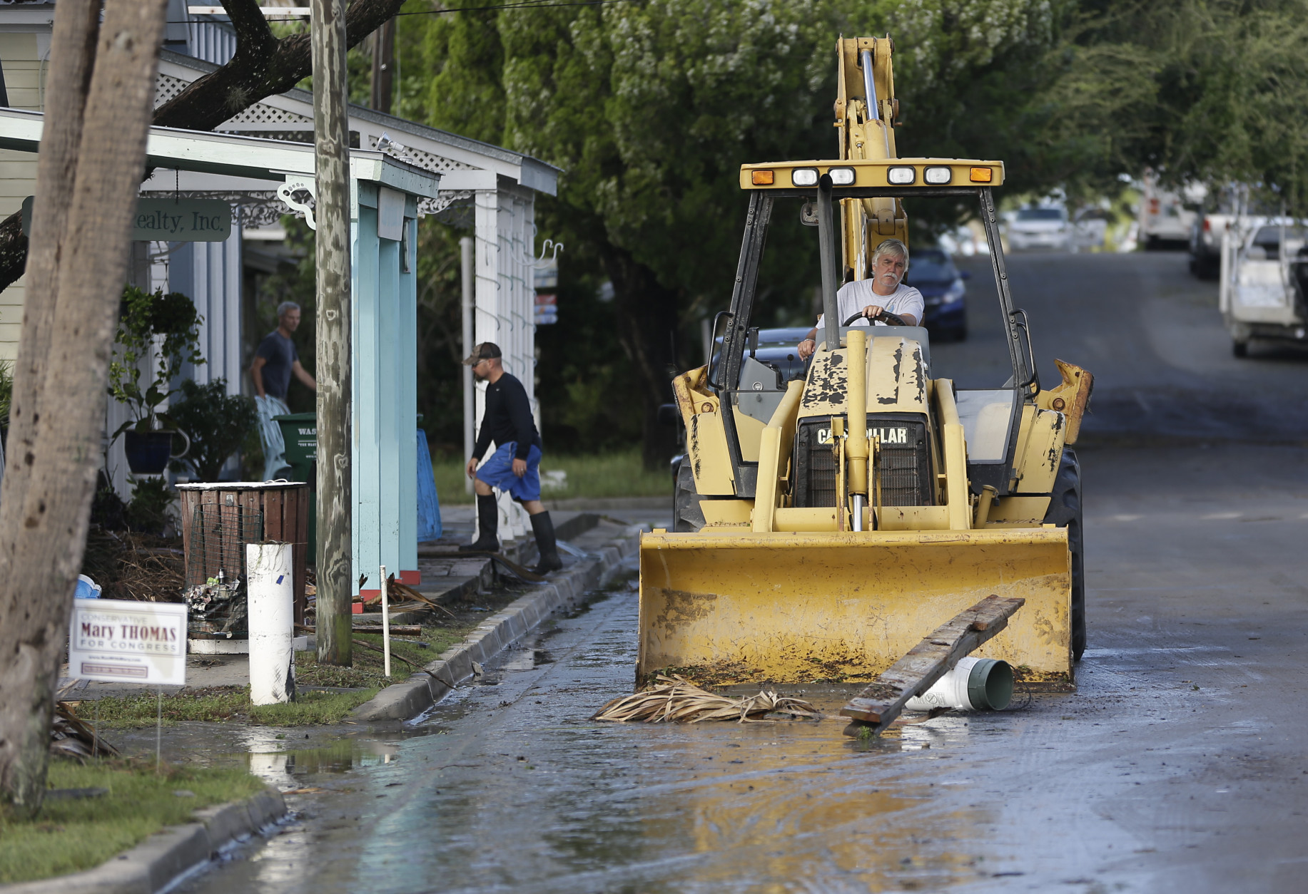 A front end loader clears debris from the street after Hurricane Hermine passed through Friday, Sept. 2, 2016, in Cedar Key, Fla. Hermine was downgraded to a tropical storm after it made landfall. (AP Photo/John Raoux)