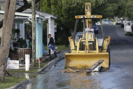 A front end loader clears debris from the street after Hurricane Hermine passed through Friday, Sept. 2, 2016, in Cedar Key, Fla. Hermine was downgraded to a tropical storm after it made landfall. (AP Photo/John Raoux)
