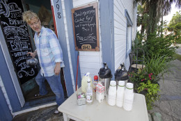 Martin Kemp offers free coffee outside his coffee shop to residents and local business owners after Hurricane Hermine flooded his shop, Friday, Sept. 2, 2016, in Cedar Key, Fla. Kemp's shop had only been open for four days before the storm hit. (AP Photo/John Raoux)