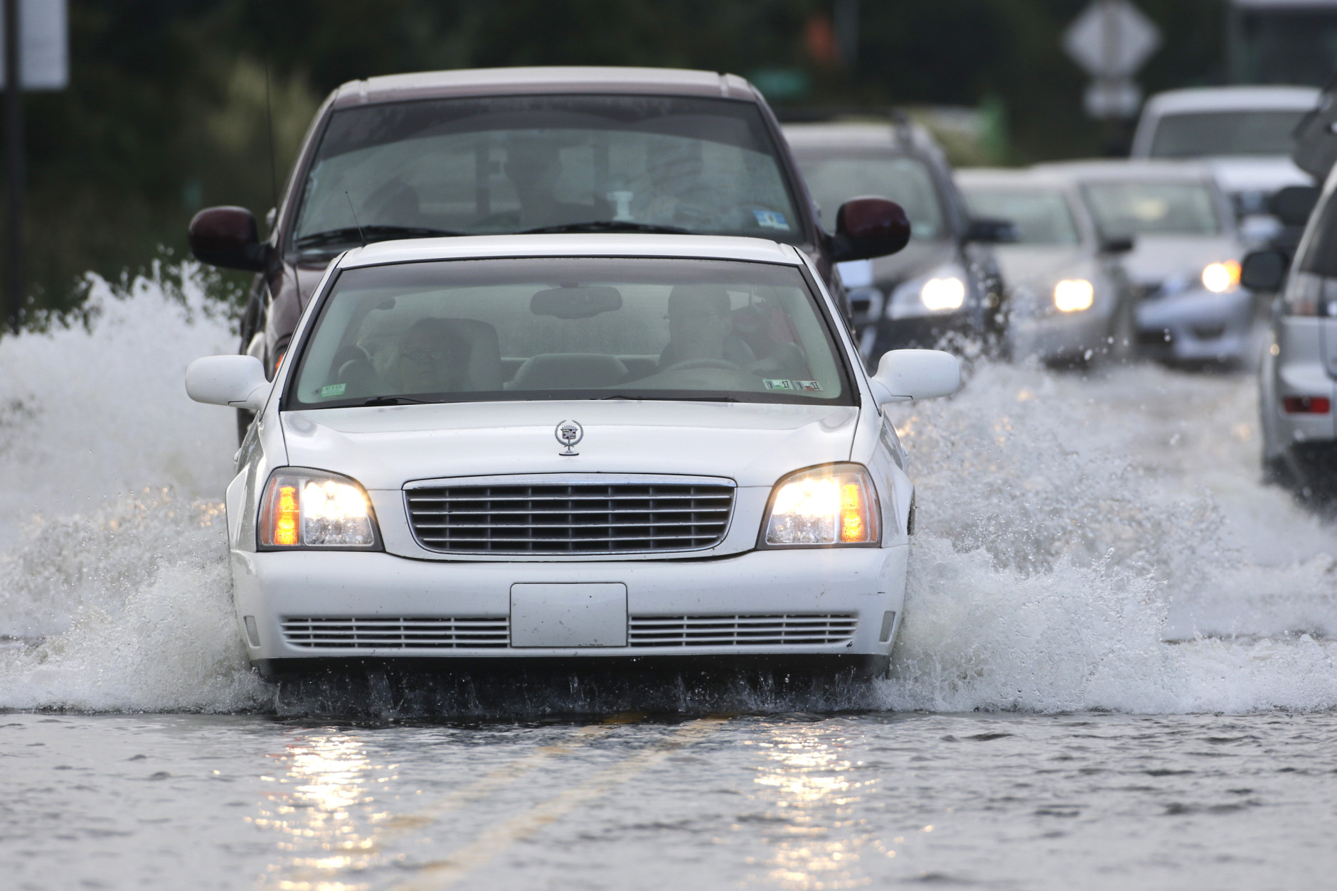 Cars drive on the flood NC Hwy 12 in Rodanthe, N.C., Saturday, Sept. 3, 2016 after Tropical Storm Hermine passed the Outer Banks.  The storm is expected to dump several inches of rain in parts of coastal Virginia, Maryland, Delaware, New Jersey and New York as the Labor Day weekend continues.  (AP Photo/Tom Copeland)
