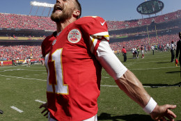 Kansas City Chiefs quarterback Alex Smith celebrates after an NFL football game against the San Diego Chargers Sunday, Sept. 11, 2016, in Kansas City, Mo. Kansas City won 33-27 in overtime. (AP Photo/Charlie Riedel)