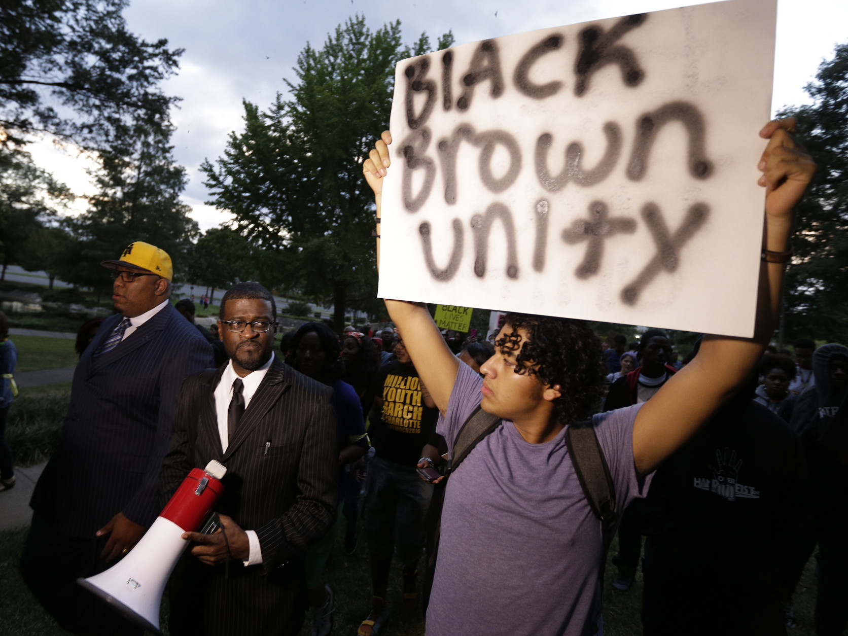 Demonstrators protest Tuesday's fatal police shooting of Keith Lamont Scott in Charlotte, N.C. on Wednesday, Sept. 21, 2016. Authorities tried to quell public anger and correct what they characterized as false information Wednesday after a night of looting and arson added Charlotte to the list of U.S. cities that have erupted in violence over the death of a black man at the hands of police.With officials refusing to release any video of the shooting of 43-year-old Keith Lamont Scott, two starkly different versions emerged: Police say Scott disregarded repeated demands to drop his gun, while neighborhood residents say he was holding a book, not a weapon, as he waited for his son to get off the school bus. (AP Photo/Chuck Burton)