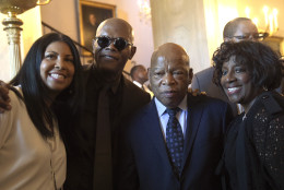 Actor Samuel L. Jackson, second from left, and Rep. John Lewis, D-Ga., second from right, pose for a photo during a reception in the Grand Foyer of the White House in Washington, Friday, Sept. 23, 2016, for the opening of the Smithsonian's National Museum of African American History and Culture. At left is Cookie Johnson, wife of Magic Johnson. (AP Photo/Susan Walsh)
