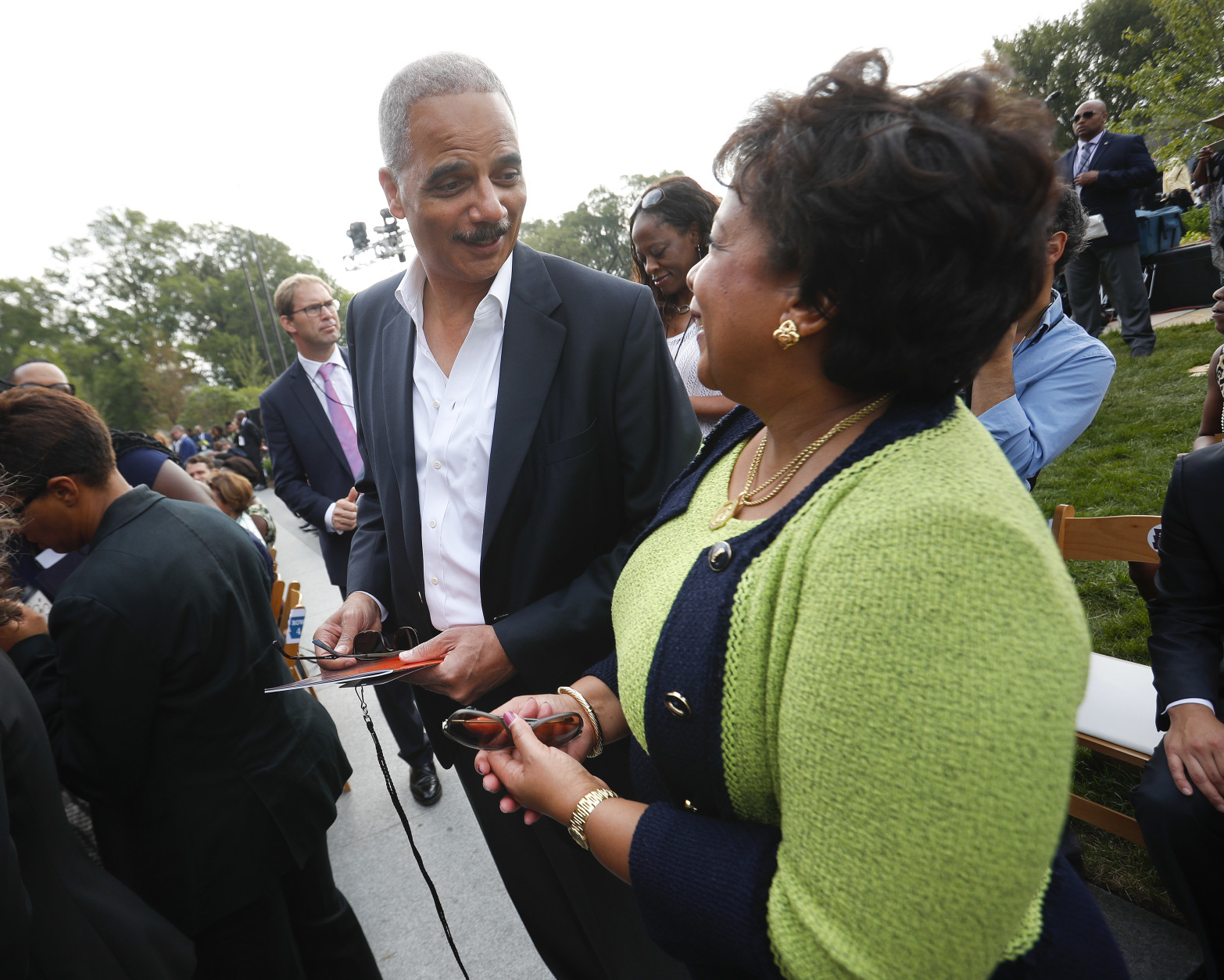 Former Attorney General Eric Holder, left, talks with current Attorney General Loretta Lynch as they arrive for the dedication ceremony of the Smithsonian Museum of African American History and Culture on the National Mall in Washington, Saturday, Sept. 24, 2016. (AP Photo/Pablo Martinez Monsivais)
