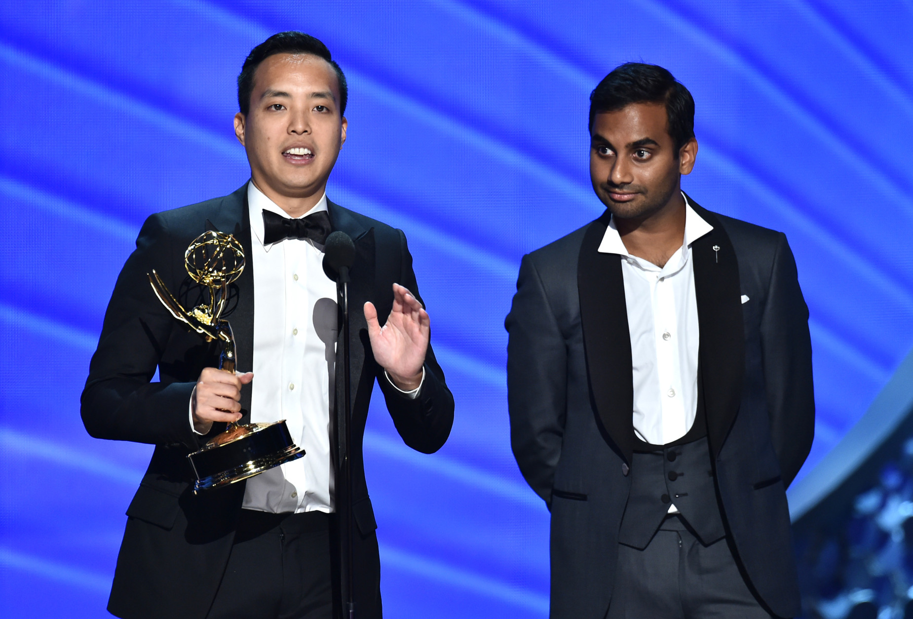 Kelvin Yu, left, and Aziz Ansari accept the award for outstanding writing for a comedy series for Master of None at the 68th Primetime Emmy Awards on Sunday, Sept. 18, 2016, at the Microsoft Theater in Los Angeles. (Photo by Vince Bucci/Invision for the Television Academy/AP Images)