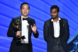Kelvin Yu, left, and Aziz Ansari accept the award for outstanding writing for a comedy series for Master of None at the 68th Primetime Emmy Awards on Sunday, Sept. 18, 2016, at the Microsoft Theater in Los Angeles. (Photo by Vince Bucci/Invision for the Television Academy/AP Images)