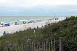 In this June 9, 2015 photo, umbrella chairs dot the beach along County Road 30A in the Florida Panhandle, in Walton County, Fla. "Nashville South," a once quiet, isolated about 26-mile stretch of the Panhandle between Destin and Panama City that has transformed into a vacation capital for the South's rich and famous. (AP Melissa Nelson-Gabriel)