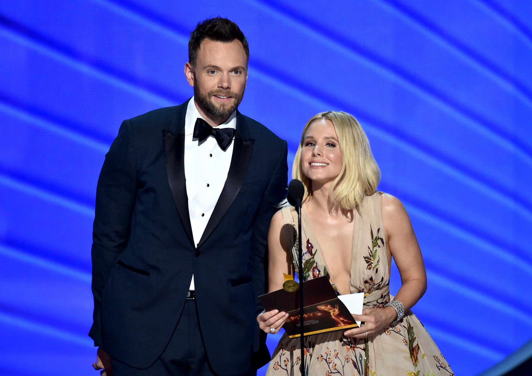Joel McHale, left, and Kristen Bell present the award for outstanding supporting actress in a comedy series at the 68th Primetime Emmy Awards on Sunday, Sept. 18, 2016, at the Microsoft Theater in Los Angeles. (Photo by Vince Bucci/Invision for the Television Academy/AP Images)