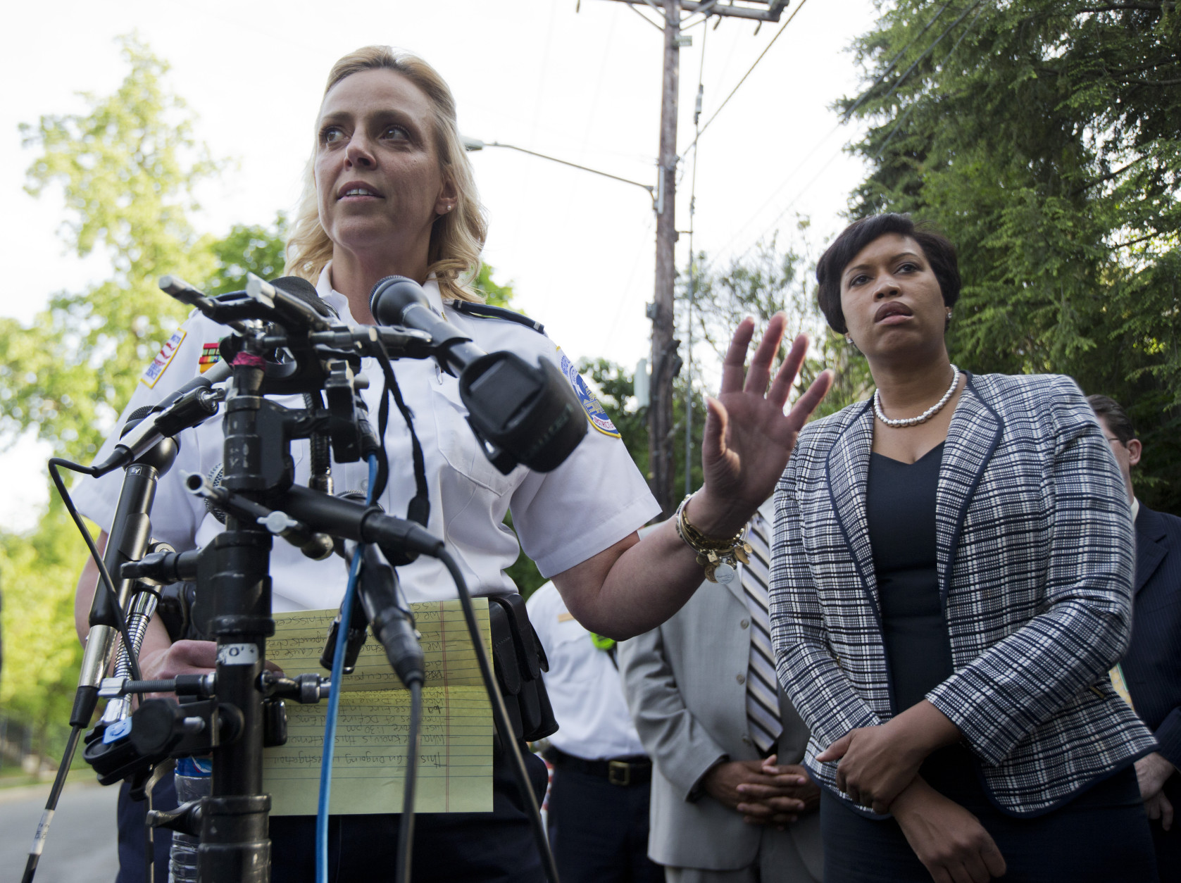 District of Columbia Police Chief Cathy Lanier, left, with Mayor Muriel Bowser, talks to reporters about a fire at a home in Northwest Washington, Thursday, May 14, 2015, where four people were found dead after firefighters entered a home in an upscale Washington neighborhood.  (AP Photo/Manuel Balce Ceneta)