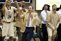 George Washington head coach Mike Lonergan, center, reacts with his team during the second half of an NCAA college basketball game against Rutgers, Wednesday, Dec. 4, 2013, in Washington. George Washington won 93-87. (AP Photo/Alex Brandon)
