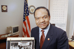 Former District of Columbia Rep. Walter Fauntroy points to a photograph he holds in his Washington office showing the Rev. Martin Luther King Jr in a 1963 civil rights march  March 29, 1993. Fauntroy, who headed the House committee that investigated Kings assassination, has joined historians calling for an independent re-investigation of the civil rights leaders death 25 years ago in Memphis. (AP Photo/Charles Tasnadi)