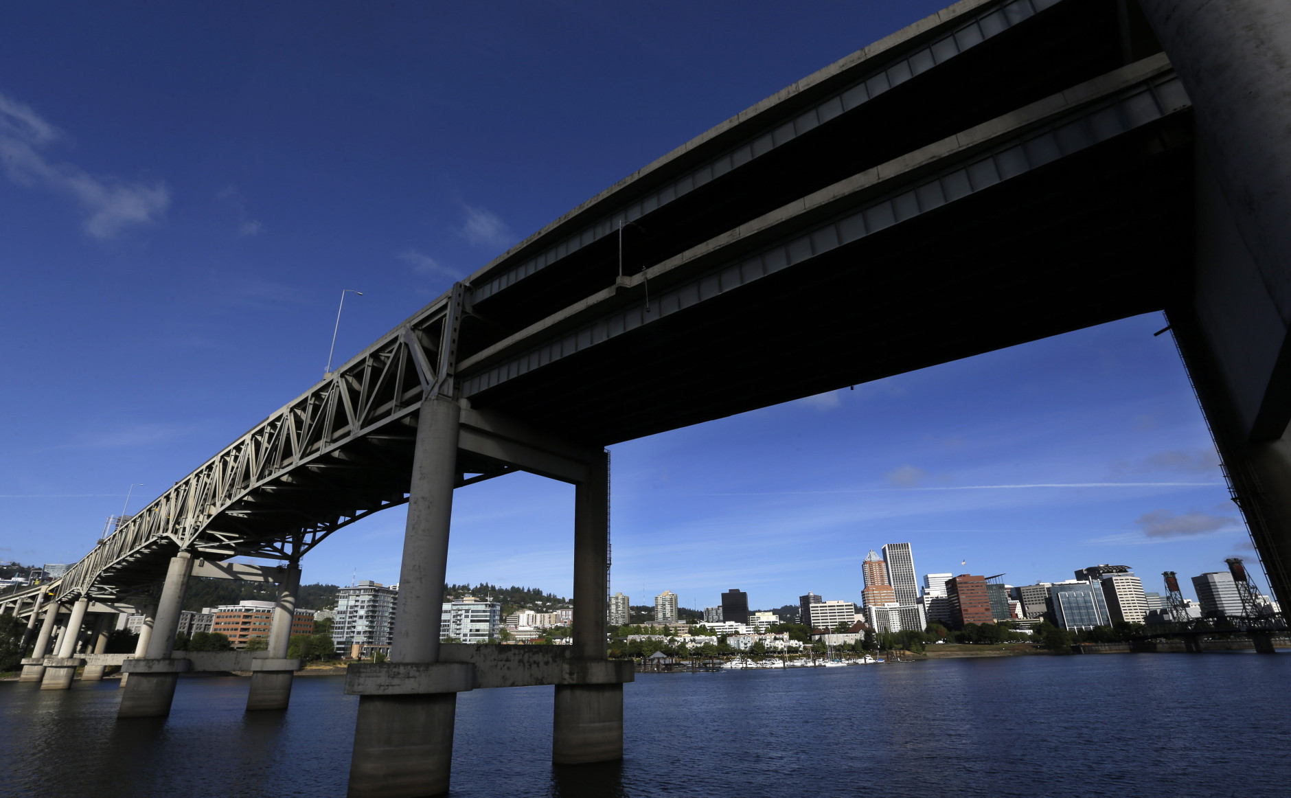 FILE - In this Aug. 4, 2015, file photo, downtown Portland, Ore., is visible under the Interstate-5 Marquam Bridge on the Willamette River. There are numerous bridges in Portland spanning the river, varying in age and ability to withstand a major earthquake. For the past few years emergency officials in the Pacific Northwest have been drafting detailed contingency plans for the day a mega-quake and tsunami hit the region. What planners envision is a massive response that would eclipse the response to any natural disaster so far in U.S. history.  (AP Photo/Don Ryan, File)