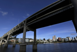 FILE - In this Aug. 4, 2015, file photo, downtown Portland, Ore., is visible under the Interstate-5 Marquam Bridge on the Willamette River. There are numerous bridges in Portland spanning the river, varying in age and ability to withstand a major earthquake. For the past few years emergency officials in the Pacific Northwest have been drafting detailed contingency plans for the day a mega-quake and tsunami hit the region. What planners envision is a massive response that would eclipse the response to any natural disaster so far in U.S. history.  (AP Photo/Don Ryan, File)