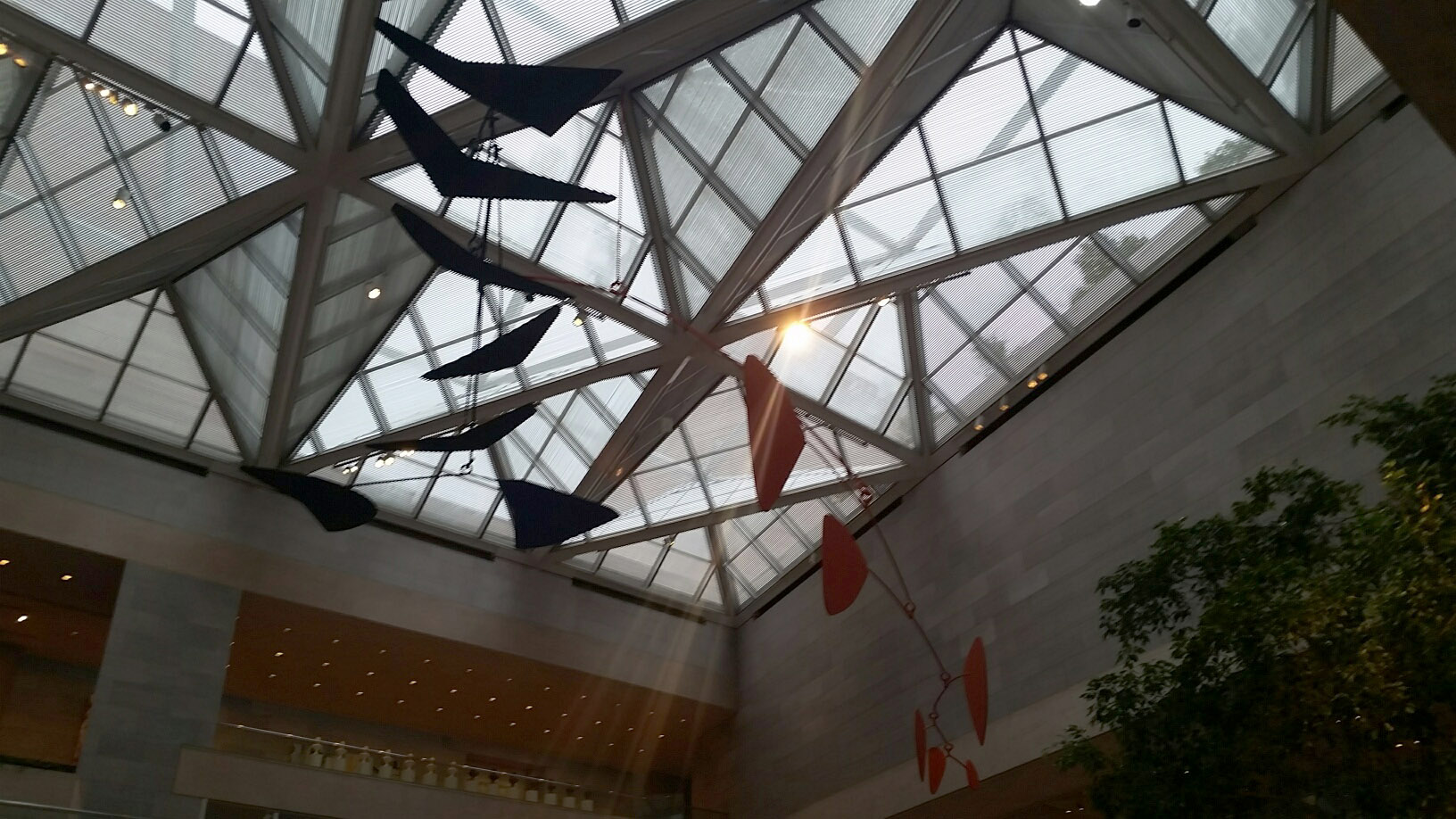 This mobile by Alexander Calder Mobile has a 76-foot wingspan and moves with the air flow inside the East Building of the National Gallery of Art.  The artist designed it for the gallery but he never got to name this work because he died before it was installed. It was his last work and his largest work.  (WTOP/Kathy Stewart)