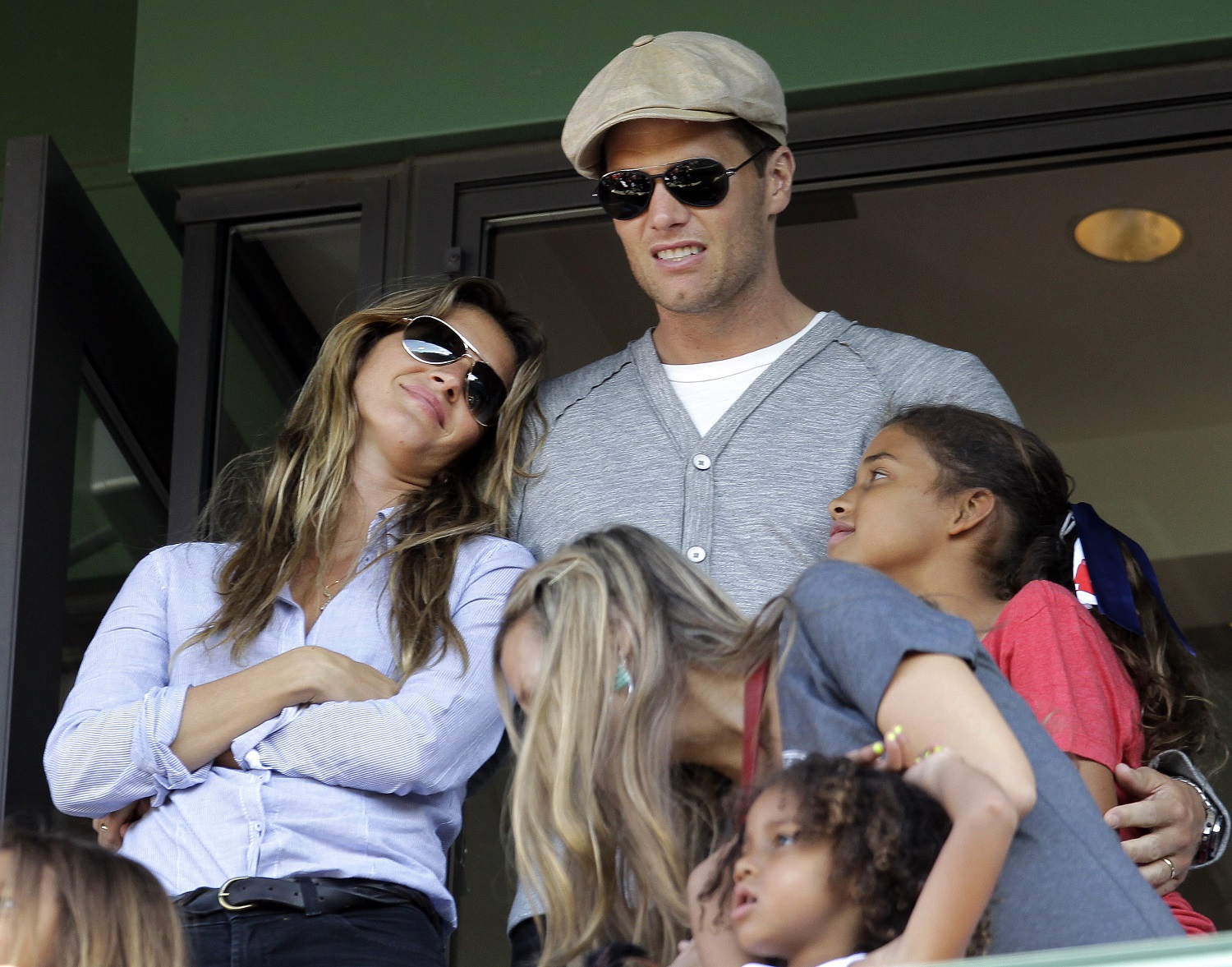 New England Patriots quarterback Tom Brady and his wife, Giselle, left, stand in a box during a baseball game between the Boston Red Sox and the New York Yankees at Fenway Park in Boston, Friday, April 20, 2012. (AP Photo/Elise Amendola)