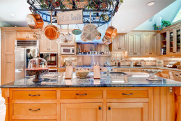 The estate features a gourmet kitchen with center island, off the formal dining room. A separate breaksfast room sits nearby. (Courtesy Monument Sotheby's International Realty)