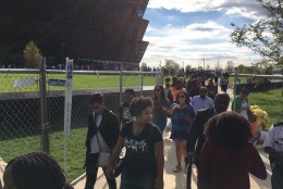 A constant stream of visitors exit the  Smithsonian’s National Museum of African American History and Culture. The museum is open until midnight on Sunday, Sept. 25, 2016. (WTOP/Liz Anderson)