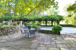 This photo provided by Thomas and Talbot Real Estate shows a patio at the Wexford Estate, the 1963 retreat that Jacqueline Kennedy Onassis designed for her family. The home is nestled on more than 166 acres in Virginia's hunt country.  (Courtesy Thomas and Talbot Real Estate and Mona Botwick Photography)