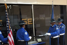 A limestone tablet from a a wall at the Pentagon damaged during the Sept. 11, 2001 terror attacks is unveiled at Dulles International Airport. Staff with the Transportation Security Administration held a ceremony to dedicate  the stone tablet on Thursday, Sept. 1, 2016. (WTOP/Kristi King)