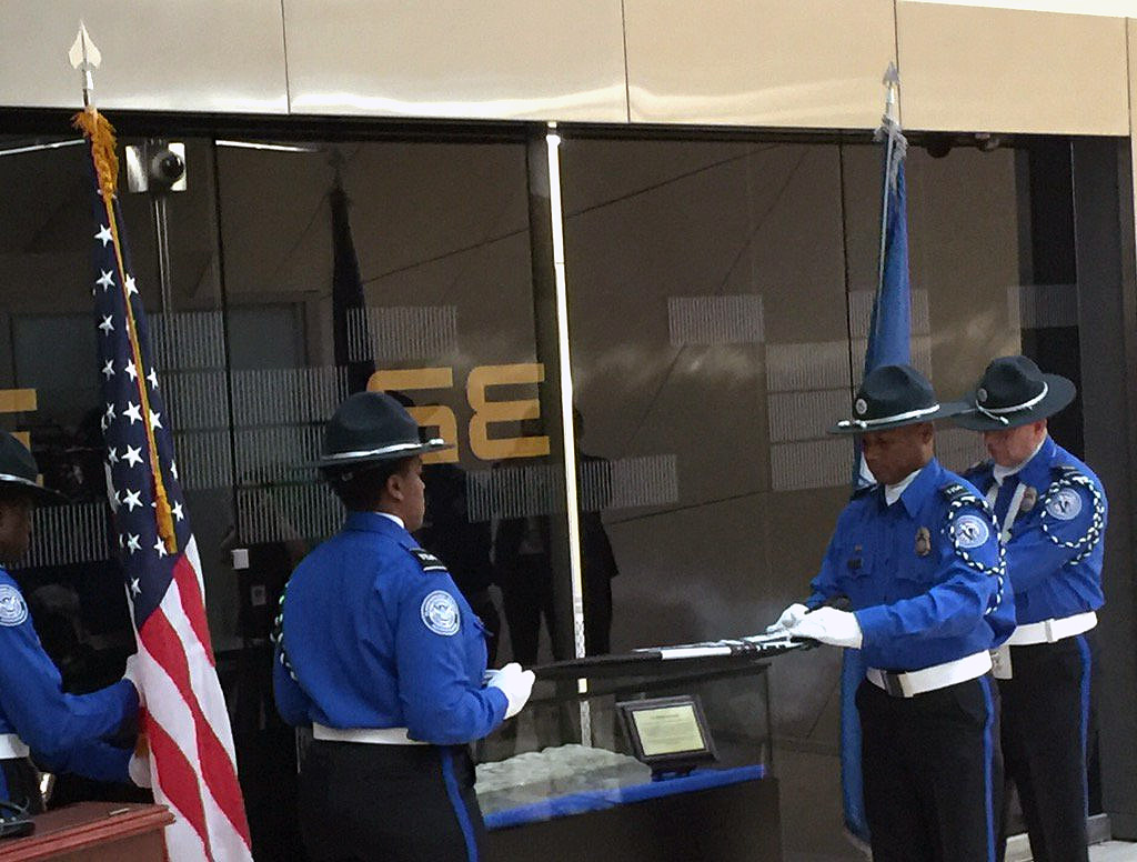 A limestone tablet from a a wall at the Pentagon damaged during the Sept. 11, 2001 terror attacks is unveiled at Dulles International Airport. Staff with the Transportation Security Administration held a ceremony to dedicate  the stone tablet on Thursday, Sept. 1, 2016. (WTOP/Kristi King)