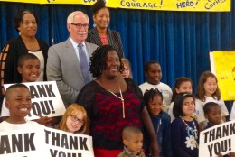 Renita Smith posed for a photo with Prince George's County Schools CEO Dr. Kevin Maxwell and the students she buses. (WTOP/Megan Cloherty)