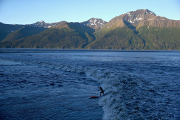ANCHORAGE, AK - JULY 14:  A surfer rides the Bore Tide at Turnagain Arm on July 14, 2014 in Anchorage, Alaska. Alaska's most famous Bore Tide, occurs in a spot on the outside of Anchorage in the lower arm of the Cook Inlet, Turnagain Arm, where wave heights can reach 6-10 feet tall, move at 10-15 mph and the water temperature stays around 40 degrees Fahrenheit. This years Supermoon substantially increased the size of the normal wave and made it a destination for surfers.  (Photo by Streeter Lecka/Getty Images)