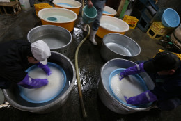 HIMEJI, JAPAN - JANUARY 22:  Japanese sake brewery workers wash rice in preparation for making sake at Tanaka Sake Brewery on January 22, 2014 in Himeji, Japan. Japanese Prime Minister Shinzo Abe targets 60 billion yen by 2020, a fivefold increase in rice-based product exports including sake.  (Photo by Buddhika Weerasinghe/Getty Images).