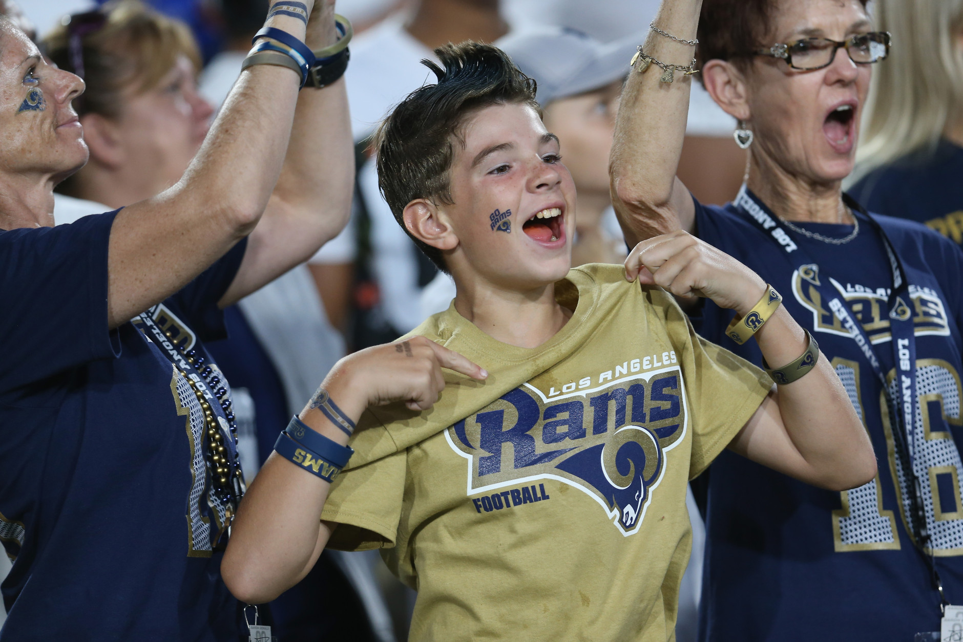 LOS ANGELES, CALIFORNIA - AUGUST 13:  A young Rams fan cheers during the game between the Dallas Cowboys and the Los Angeles Rams at the Los Angeles Coliseum during preseason on August 13, 2016 in Los Angeles, California.  The Rams won 28-24.  (Photo by Stephen Dunn/Getty Images)