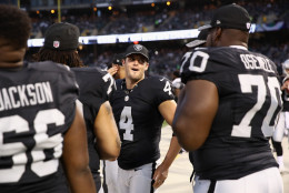 OAKLAND, CA - SEPTEMBER 01:  Derek Carr #4 of the Oakland Raiders talks to his teammates on the sidelines during their preseason game against the Seattle Seahawks at the Oakland Alameda County Coliseum on September 1, 2016 in Oakland, California.  (Photo by Ezra Shaw/Getty Images)