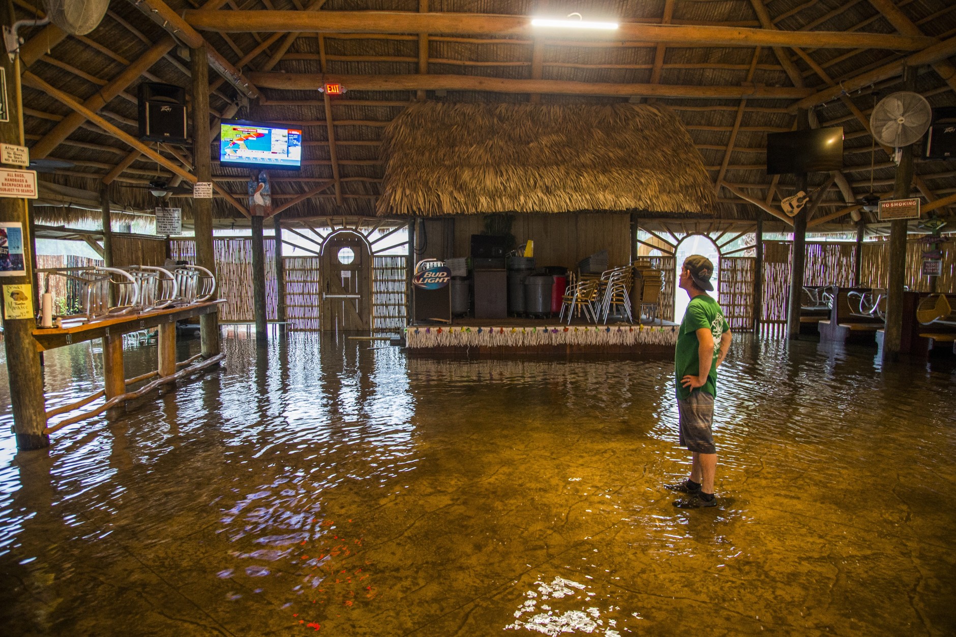 SAINT MARKS, FL - SEPTEMBER 01: Brian Mugrage watches the weather on TV inside the Riverside Cafe flooded by the storm surge from Hurricane Hermine on September 1, 2016 in Saint Marks, Florida.  Hurricane warnings have been issued for parts of Florida's Gulf Coast as Hermine is expected to make landfall as a Category 1 hurricane (Photo by Mark Wallheiser/Getty Images)