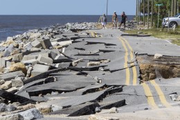 ALLIGATOR POINT, FL - SEPTEMBER 02:  Residents look at Alligator Point road that collapsed during the storm surge from Hurricane Hermine at Alligator Point, Florida on September 2, 2016. Hermine made landfall as a Category 1 hurricane but has weakened back to a tropical storm. (Photo by Mark Wallheiser/Getty Images)