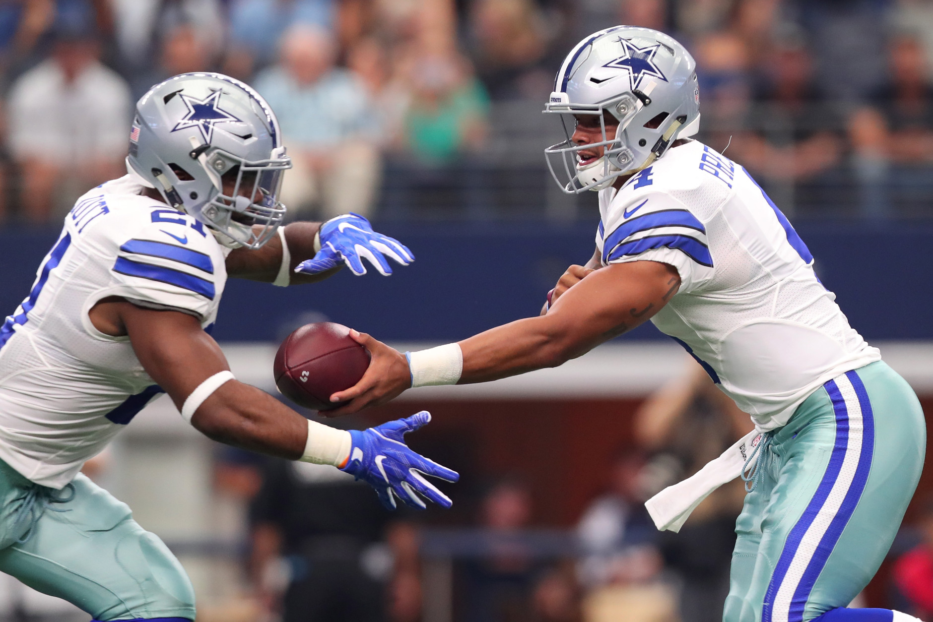 ARLINGTON, TX - SEPTEMBER 11:  Dak Prescott #4 hands the ball to Ezekiel Elliott #21 of the Dallas Cowboys during the first quarter against the New York Giants at AT&amp;T Stadium on September 11, 2016 in Arlington, Texas.  (Photo by Tom Pennington/Getty Images)