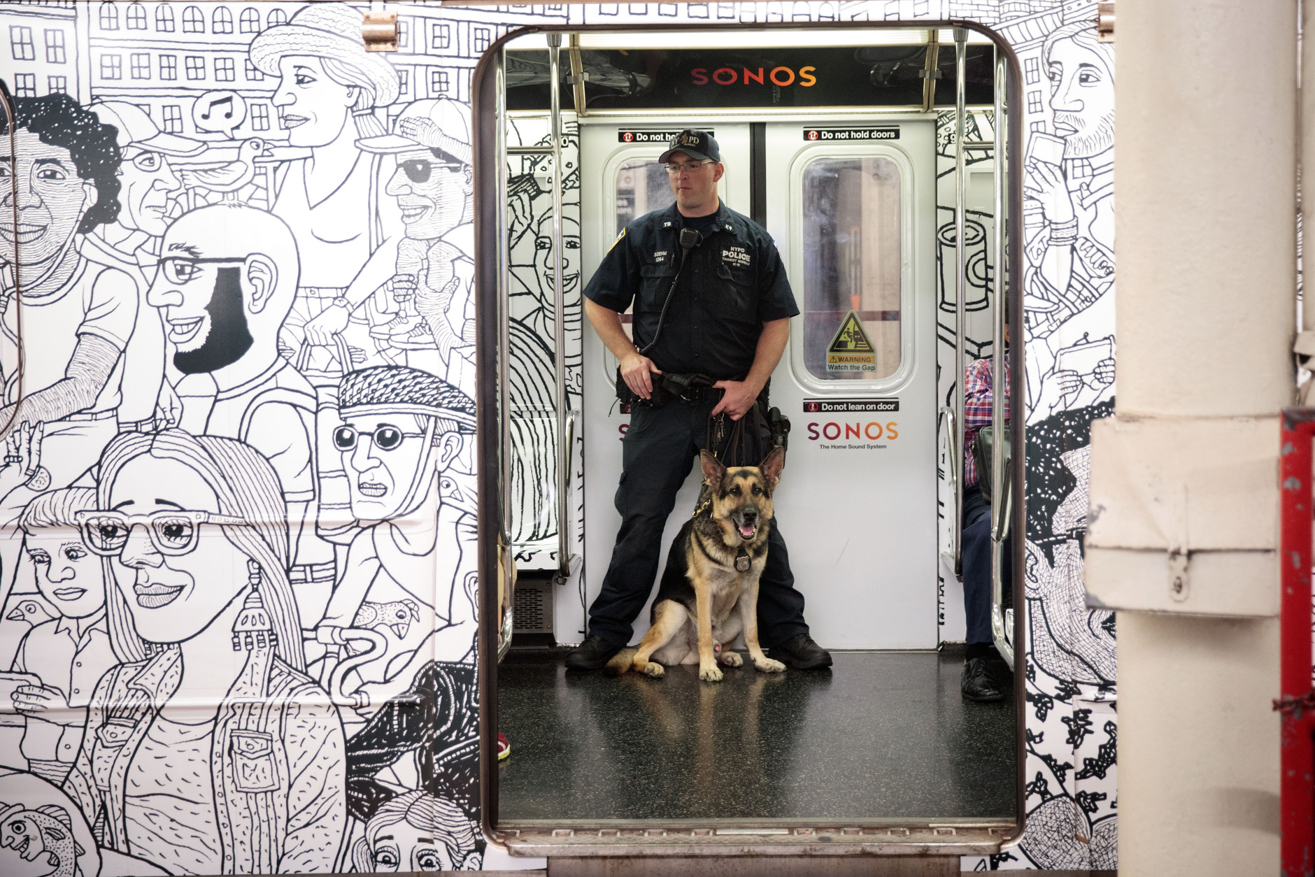 NEW YORK, NY - SEPTEMBER 18: A member of the New York City Police Department K-9 Unit patrols on a subway train between Grand Central Terminal and Times Square, September 18, 2016 in New York City. Following Saturday night's explosion in the Chelsea neighborhood of Manhattan, Mayor Bill de Blasio has promised a 'substantial' police presence throughout the week. New York Governor Andrew Cuomo also said an additional 1,000 New York State and National Guard troops will patrol transit stations and airports as a precaution. (Photo by Drew Angerer/Getty Images)