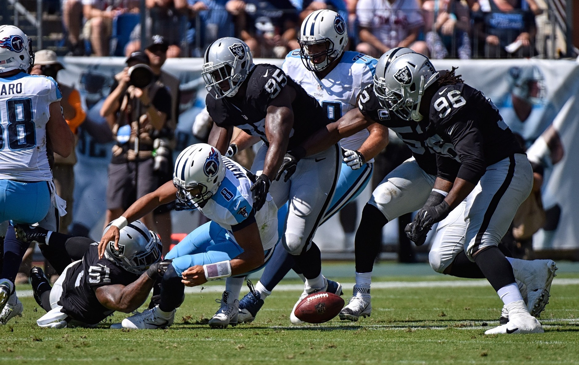 NASHVILLE, TN - SEPTEMBER 25:  Bruce Irvin #51 of the Oakland Raiders causes quarterback Marcus Mariota #8 of the Tennessee Titans to fumble during the first half at Nissan Stadium on September 25, 2016 in Nashville, Tennessee.  (Photo by Frederick Breedon/Getty Images)