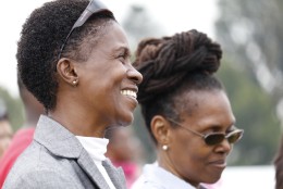 Women in the crowd smile at the opening dedication ceremony of the Museum of African American History and Culture. (WTOP/Kate Ryan)