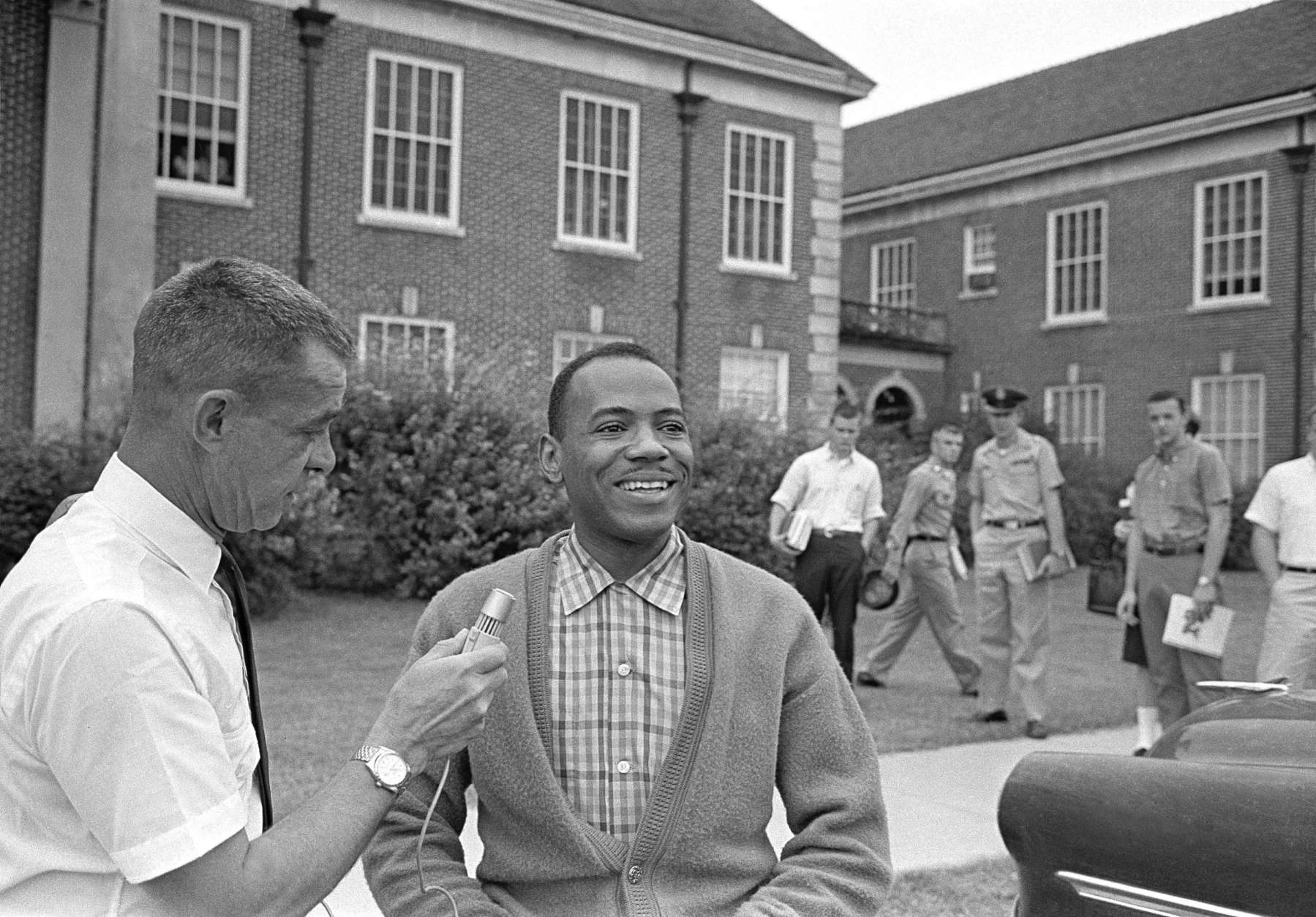 African American James H. Meredith grins as he answers a question at an impromptu conference between classes at the University of Mississippi in Oxford, Miss., on Oct. 11, 1962. Meredith, who integrated Ole Miss, walked from class to class this morning alone. Students gathered in small groups but were silent. (AP Photo/Jim Bourdier)
