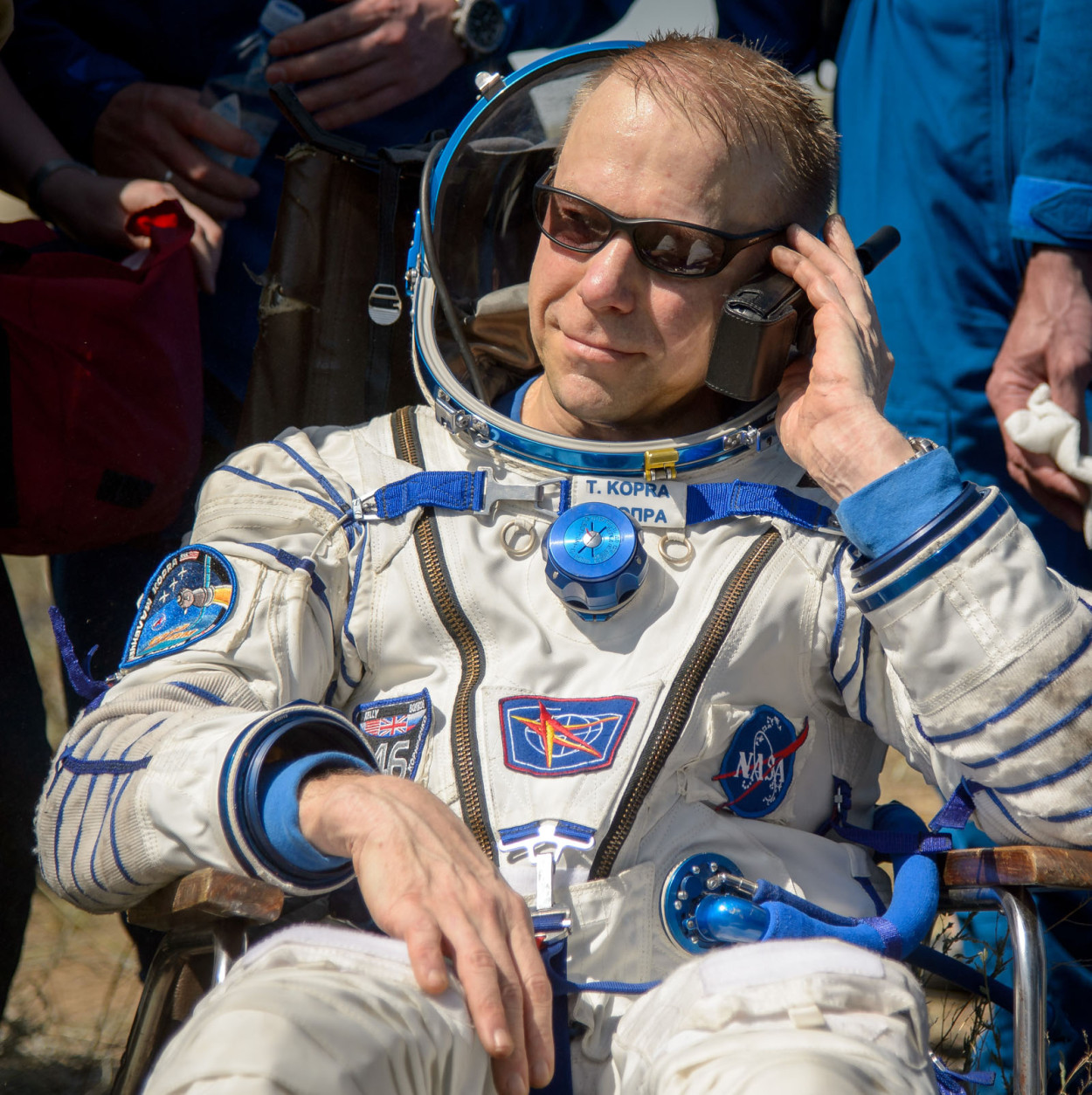 Tim Kopra of NASA talks on a satellite phone outside the Soyuz TMA-19M spacecraft just minutes after he and Yuri Malenchenko of Roscosmos and Tim Peake of the European Space Agency landed in a remote area near the town of Zhezkazgan, Kazakhstan on Saturday, June 18, 2016.  Kopra, Peake, and Malenchenko are returning after six months in space where they served as members of the Expedition 46 and 47 crews onboard the International Space Station. Photo Credit: (NASA/Bill Ingalls)