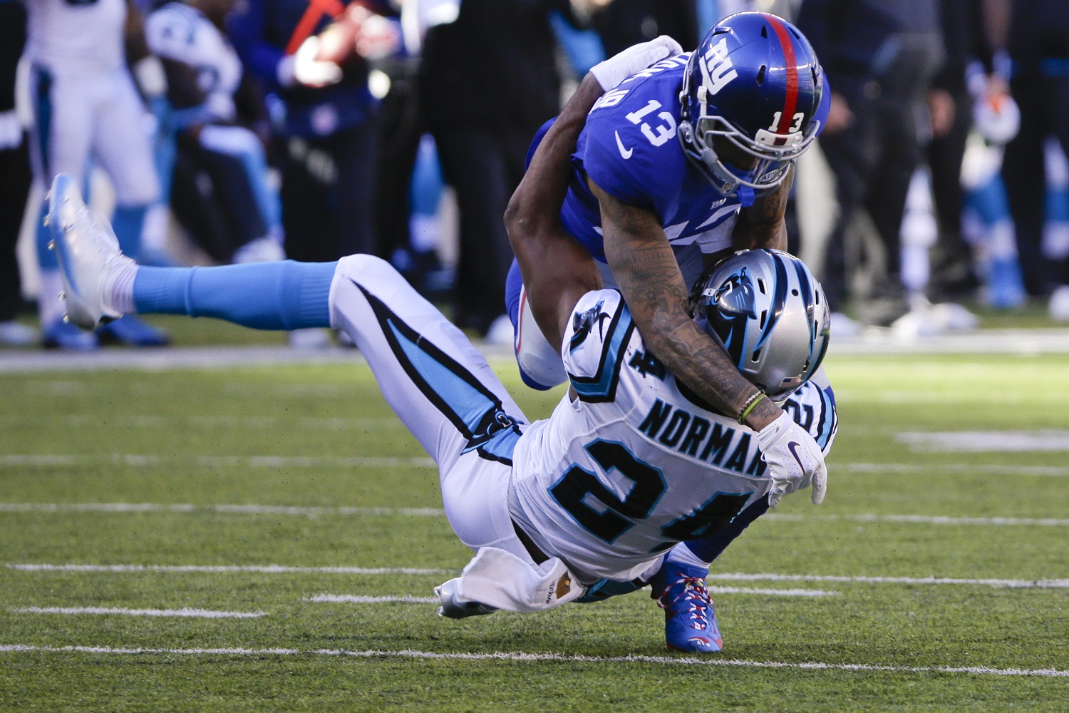 FILE - In this Sunday, Dec. 20, 2015, file photo, New York Giants wide receiver Odell Beckham Jr. (13) and Carolina Panthers' Josh Norman (24) battle during the first half of an NFL football game in East Rutherford, N.J. Beckham  isn't changing the way he plays, just the actions that led to his recent one-game suspension for multiple violations of safety-related playing rules. (AP Photo/Julie Jacobson, File)