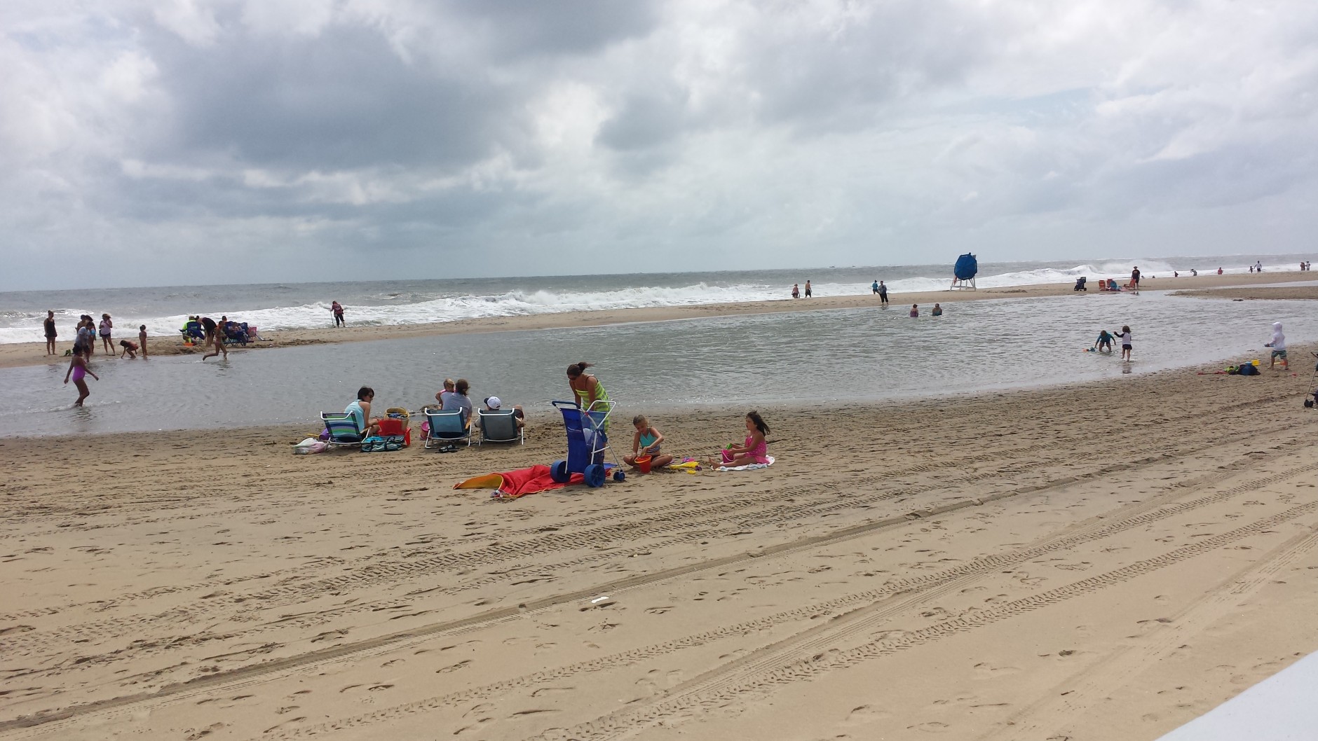 Beachgoers make due at Ocean City, Md. on Sunday, Sept. 4, 2016 as Hermine makes its way up the East Coast and farther out to sea. Ocean City officials say that despite sunny skies and calm conditions, strong rip currents and chances for beach erosion remain high. (WTOP/Colleen Kelleher)