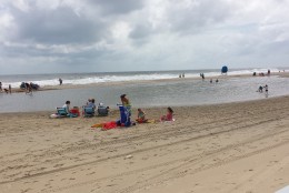 Beachgoers make due at Ocean City, Md. on Sunday, Sept. 4, 2016 as Hermine makes its way up the East Coast and farther out to sea. Ocean City officials say that despite sunny skies and calm conditions, strong rip currents and chances for beach erosion remain high. (WTOP/Colleen Kelleher)