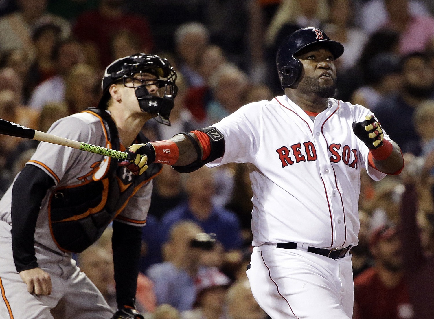 Boston Red Sox designated hitter David Ortiz, right, hits a solo homer as Baltimore Orioles catcher Matt Wieters watches in the sixth inning of a baseball game at Fenway Park, Monday, Sept. 12, 2016, in Boston. (AP Photo/Elise Amendola)