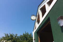 The thermometer hanging outside the barn at Poolesville Golf Course may not have been an accurate measure of the temperature as much as a warning or our scores to come. (WTOP/Noah Frank)