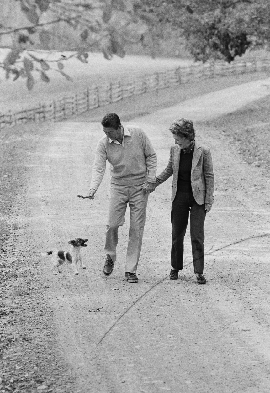 GOP Presidential candidate Ronald Reagan and wife Nancy have fun with their dog James as they take a stroll at Wexford at Middleburg, Va., on Oct. 24, 1980. Reagan took a day off from the campaign to tape a TV appearance and meet with advisors. (AP Photo/Walt Zeboski)